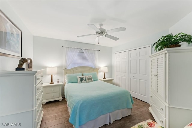 bedroom with dark wood-type flooring, ceiling fan, and a closet