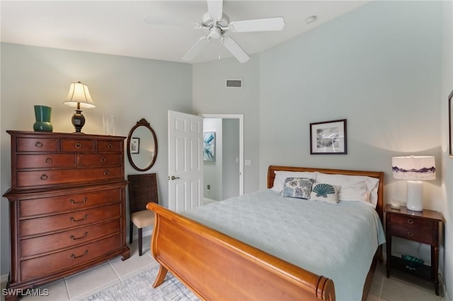 bedroom with ceiling fan and light tile patterned floors