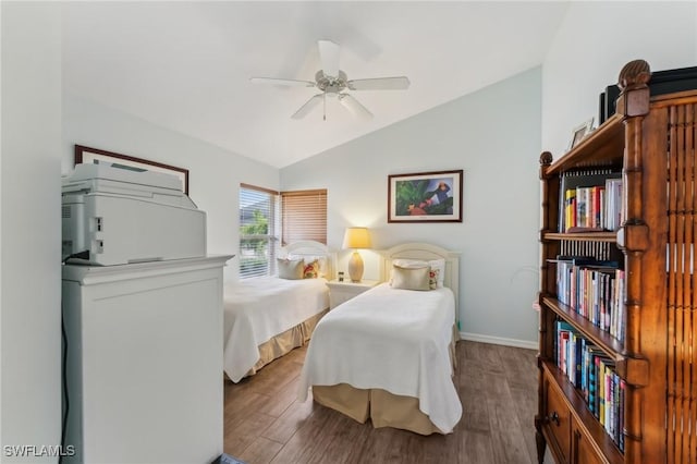 bedroom with ceiling fan, lofted ceiling, and wood-type flooring