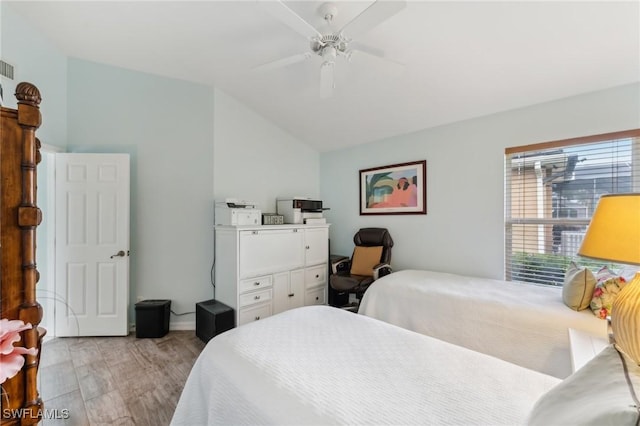 bedroom with lofted ceiling, light hardwood / wood-style flooring, and ceiling fan