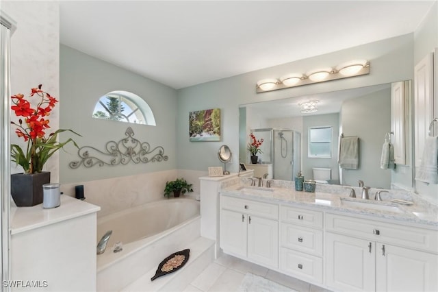 full bathroom featuring vanity, tile patterned floors, shower with separate bathtub, and toilet