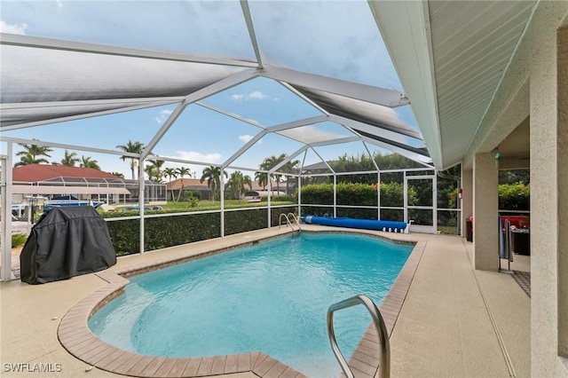 view of swimming pool featuring a lanai and a patio area