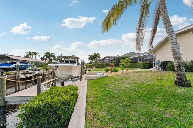 view of yard with a water view, a dock, and glass enclosure