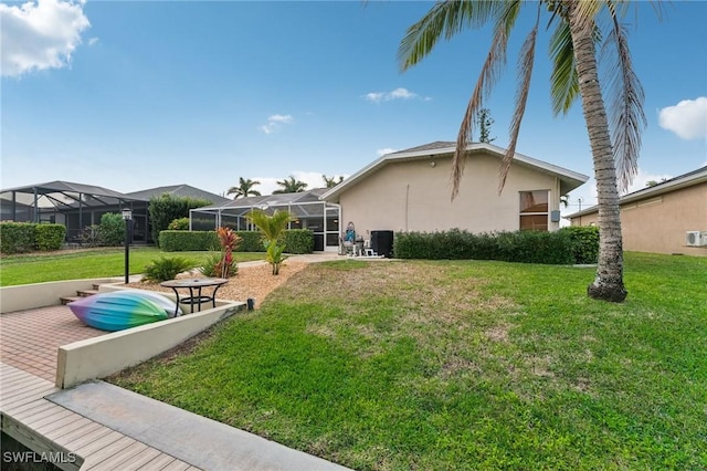 view of yard featuring a lanai and central AC unit