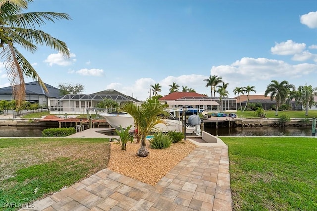 exterior space with a water view and a lawn