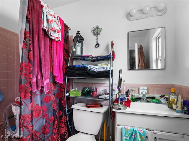 bathroom featuring toilet, vanity, and a shower with shower curtain