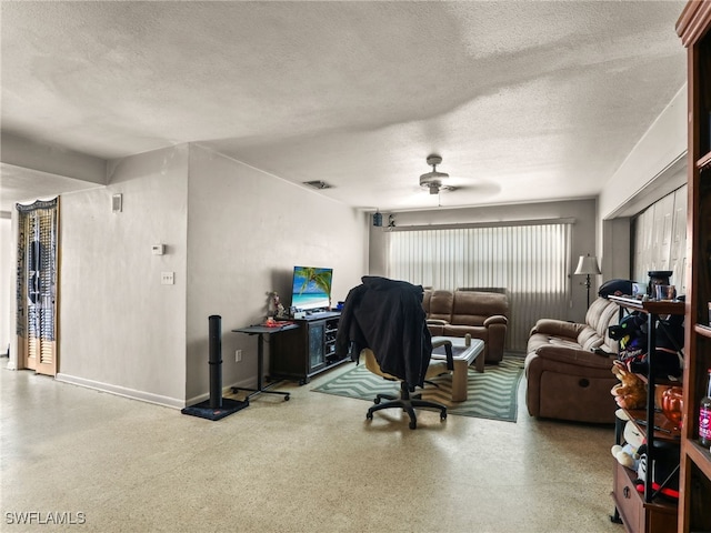 office area with a textured ceiling and ceiling fan