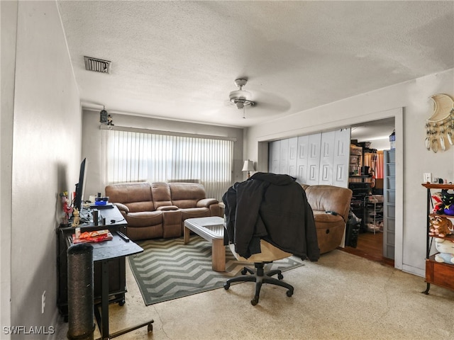 home office featuring ceiling fan and a textured ceiling