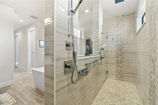 bathroom featuring wood-type flooring and independent shower and bath