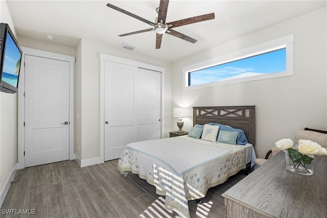 bedroom with a closet, ceiling fan, and hardwood / wood-style floors