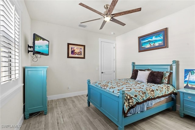 bedroom with ceiling fan and light hardwood / wood-style floors