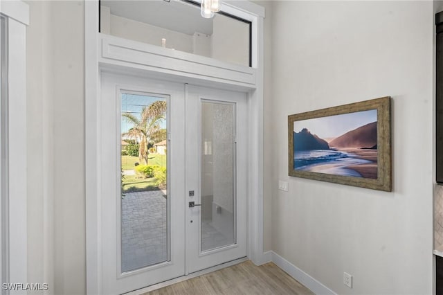 doorway with wood-type flooring and french doors