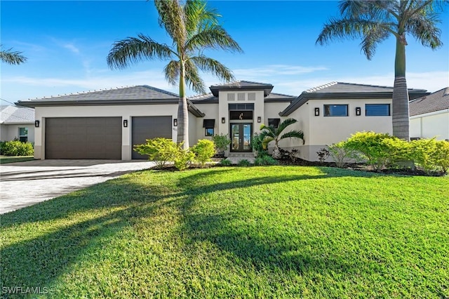 view of front of house with a front yard, french doors, and a garage