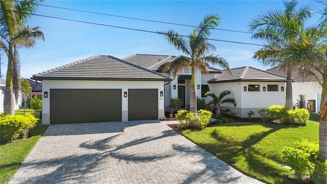 view of front facade with a front yard and a garage