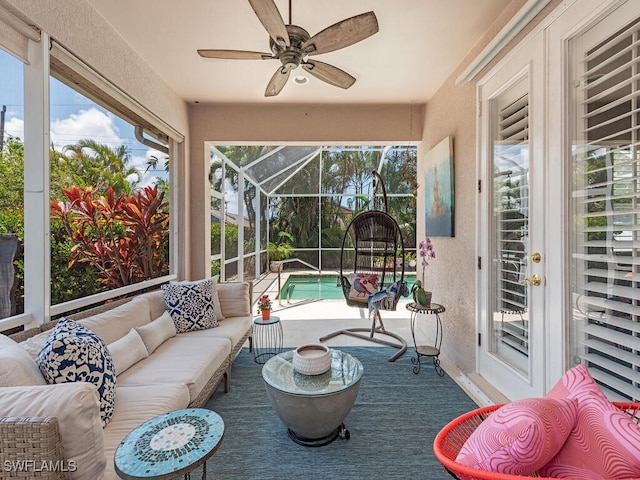 sunroom / solarium featuring ceiling fan