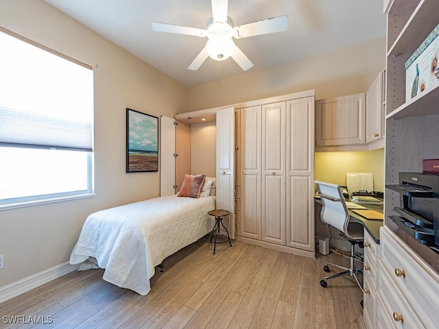 bedroom with ceiling fan and light hardwood / wood-style floors