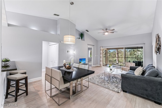 living room featuring ceiling fan, lofted ceiling, and light wood-type flooring