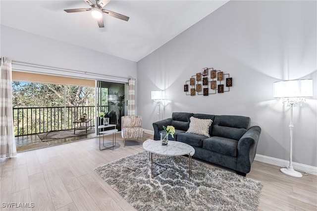 living room featuring ceiling fan, lofted ceiling, and hardwood / wood-style flooring