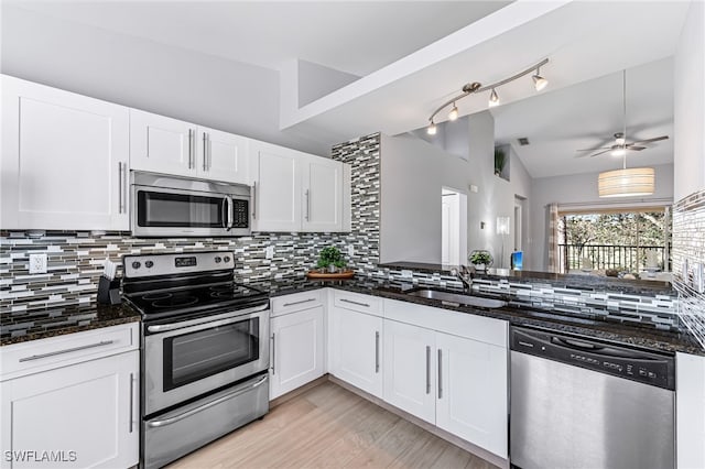 kitchen with appliances with stainless steel finishes, sink, and white cabinetry