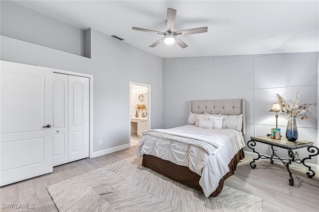 bedroom with lofted ceiling, ceiling fan, a closet, and light hardwood / wood-style floors