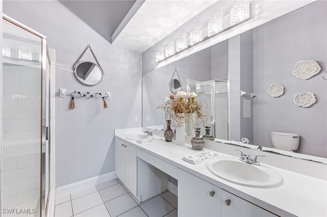 bathroom featuring vanity, toilet, tile patterned floors, and walk in shower