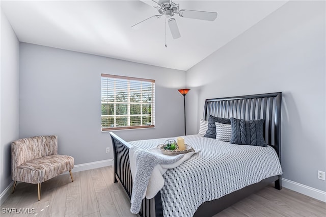 bedroom with ceiling fan and light hardwood / wood-style flooring