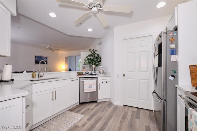 kitchen with white cabinetry, sink, kitchen peninsula, appliances with stainless steel finishes, and light wood-type flooring