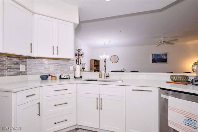 kitchen featuring backsplash, white cabinets, ceiling fan with notable chandelier, sink, and stainless steel dishwasher