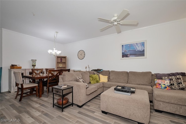 living room featuring ceiling fan with notable chandelier, light hardwood / wood-style floors, and ornamental molding