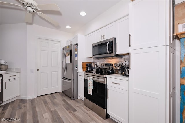 kitchen with white cabinets, ceiling fan, light wood-type flooring, appliances with stainless steel finishes, and tasteful backsplash