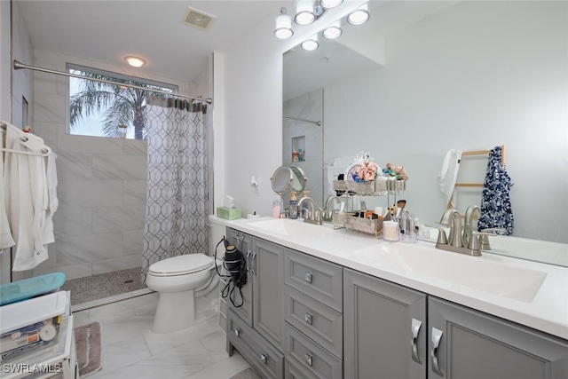 bathroom with curtained shower, vanity, and toilet