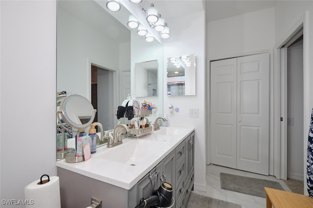 bathroom featuring tile patterned flooring and vanity