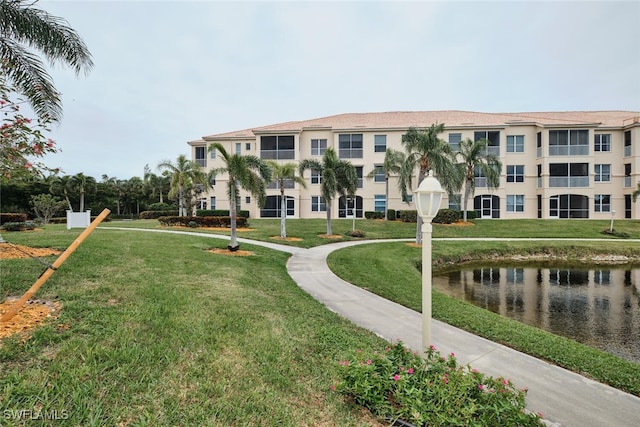 surrounding community featuring a water view and a yard