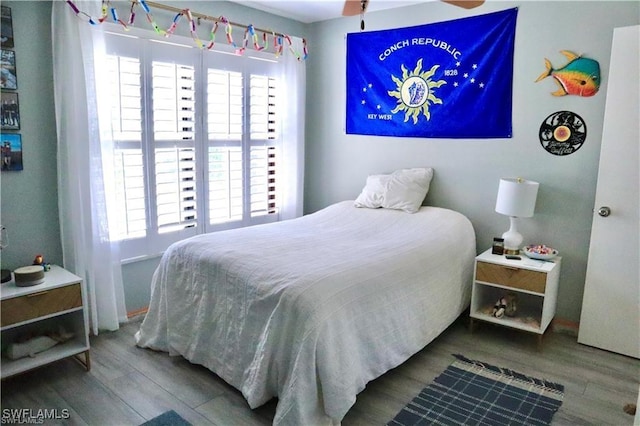 bedroom featuring hardwood / wood-style flooring and ceiling fan