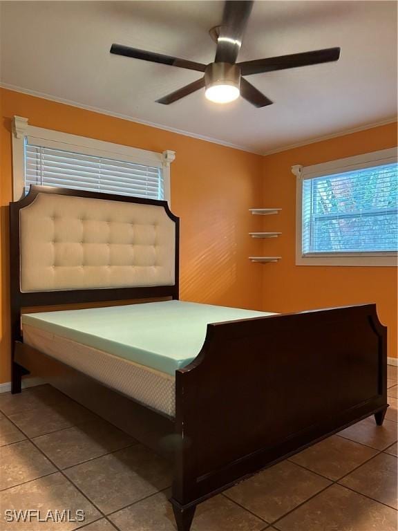 unfurnished bedroom featuring crown molding, ceiling fan, and tile patterned floors