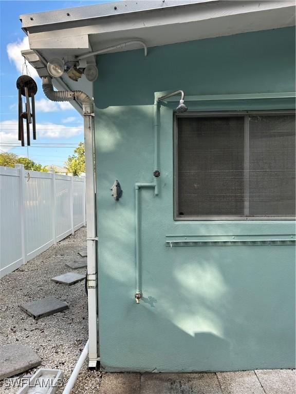 details with stucco siding and fence