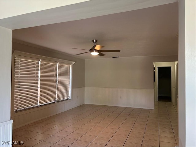 spare room with light tile patterned floors and ceiling fan