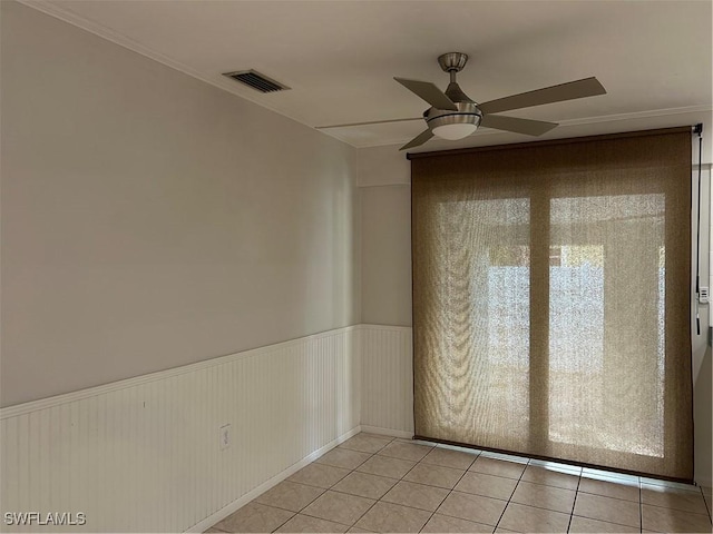 spare room with light tile patterned floors and ceiling fan