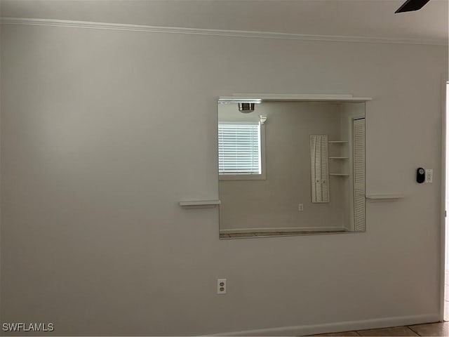 room details featuring baseboards and ornamental molding