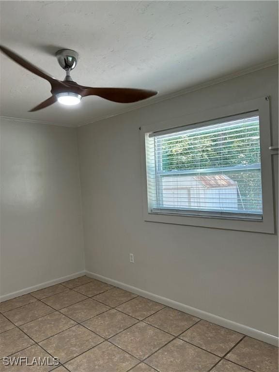 unfurnished room with plenty of natural light, baseboards, and ornamental molding