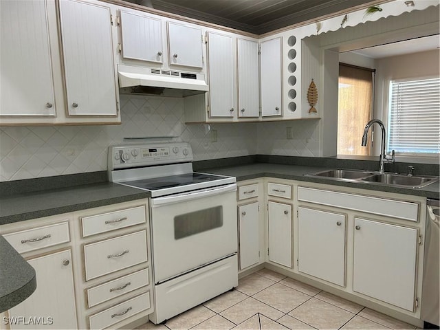 kitchen with dark countertops, under cabinet range hood, white range with electric cooktop, light tile patterned floors, and a sink