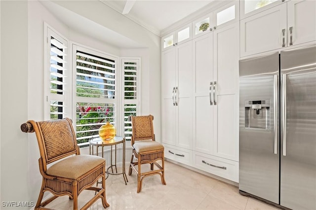 sitting room featuring light tile patterned floors and crown molding