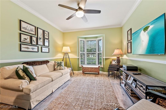 living room featuring ceiling fan, crown molding, and wood-type flooring