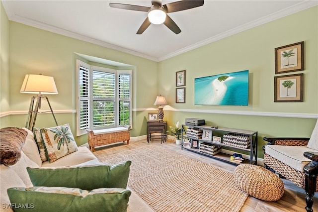 living room featuring ceiling fan, wood-type flooring, and ornamental molding