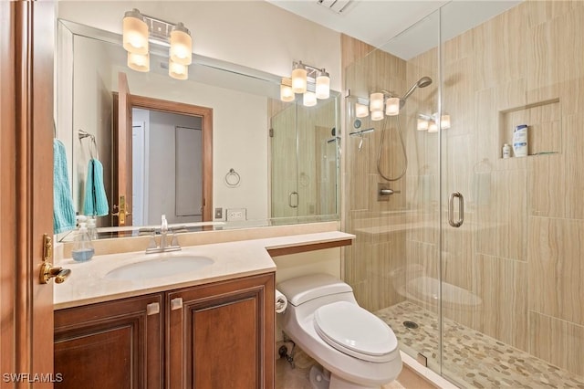 bathroom with vanity, toilet, and an enclosed shower