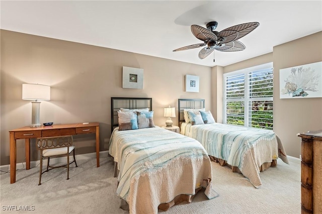 bedroom with ceiling fan and light carpet