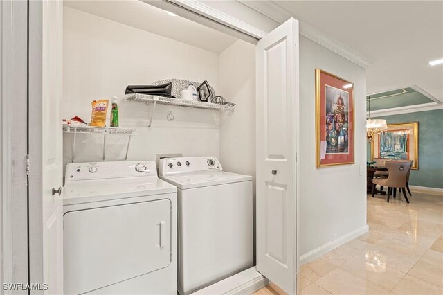 clothes washing area featuring separate washer and dryer and ornamental molding