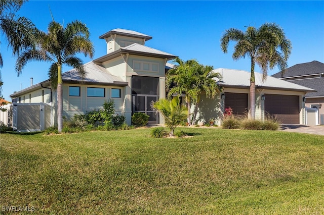 view of front facade featuring a front yard and a garage