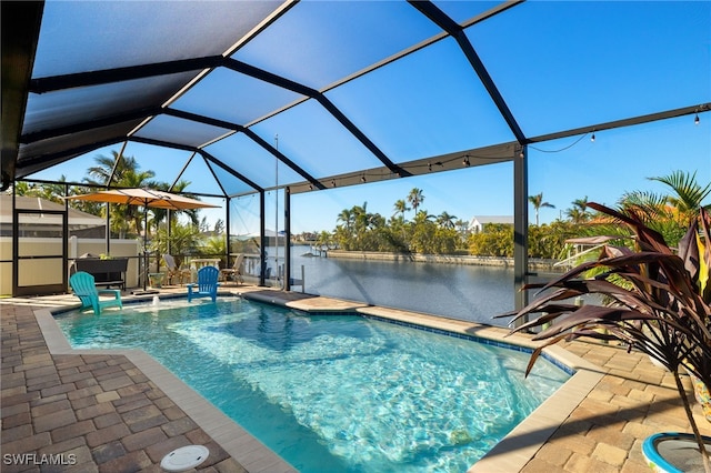 view of swimming pool featuring a patio, a water view, and a lanai