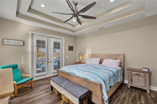 bedroom featuring french doors, a tray ceiling, ceiling fan, and access to outside